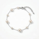Pearl bracelet with 6mm, 4mm and 3mm pearls on stainless steel chain on white background