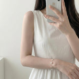 Soft Crush pearl bracelet with 6mm, 4mm and 3mm pearls on stainless steel chain worn on wrist