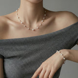 Pearl necklace with 6mm, 4mm and 3mm pearls on stainless steel chain worn on model