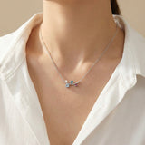 Ssoftly Lyra necklace worn on model, rhodium-plated recycled brass chain with colorful cubic zirconia stones and pearl accent, Korean jewelry