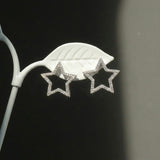 Silver star hoop earrings with pave cubic zirconia styled for editorial look